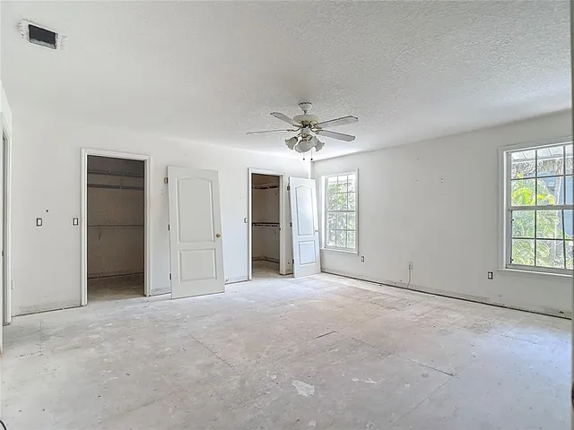 a view of a livingroom with a ceiling fan and window