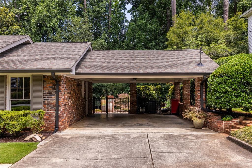 1890 Silvastone Drive Decatur, GA 30033 - Photo 45 of 48 a view of a patio with table and chairs under an umbrella