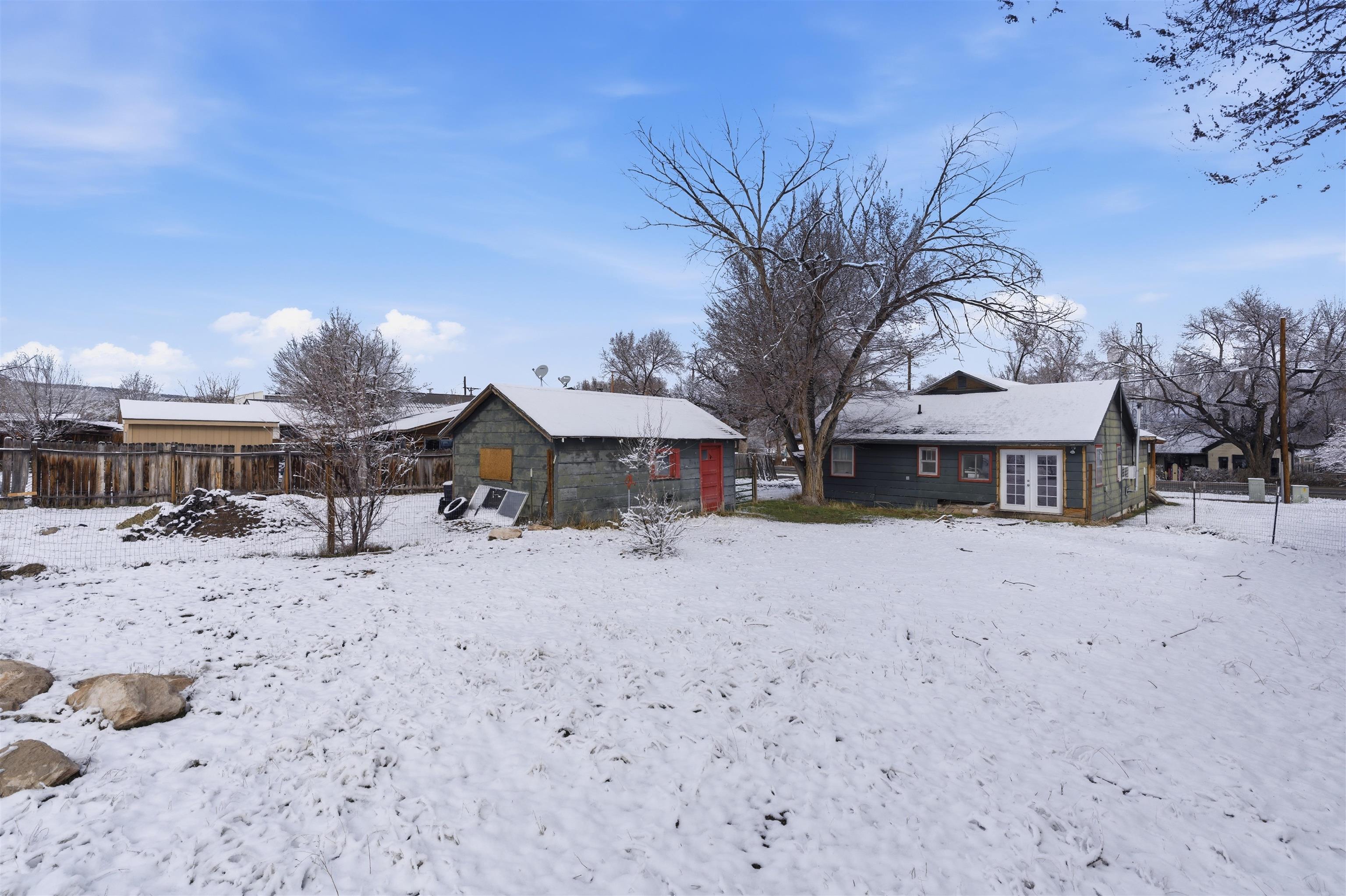 49091 KE Road Mesa, CO 81643 - Photo 12 of 29 a view of a house with a yard covered in snow