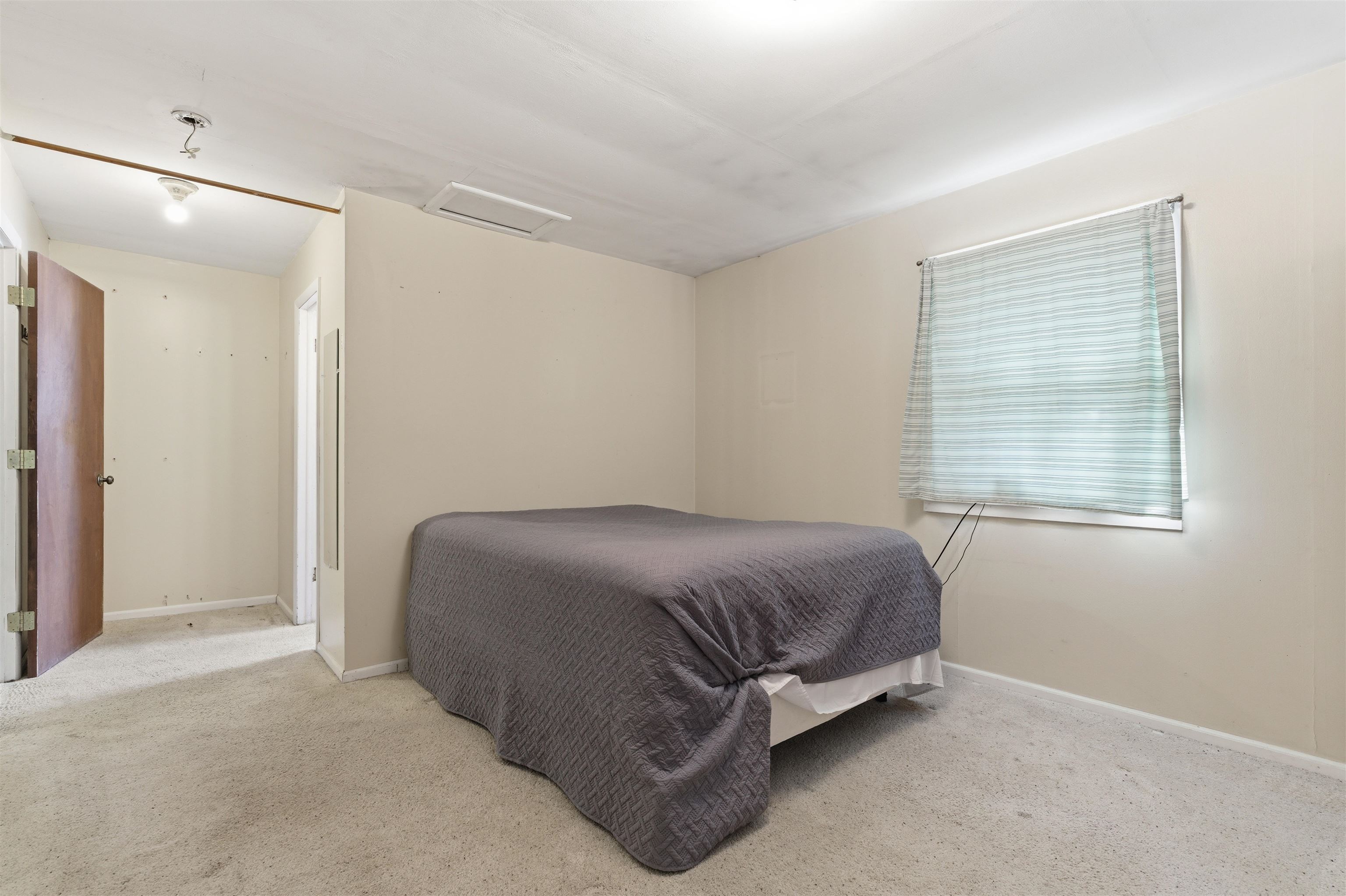 49091 KE Road Mesa, CO 81643 - Photo 18 of 29 a bed sitting in a bedroom next to a window