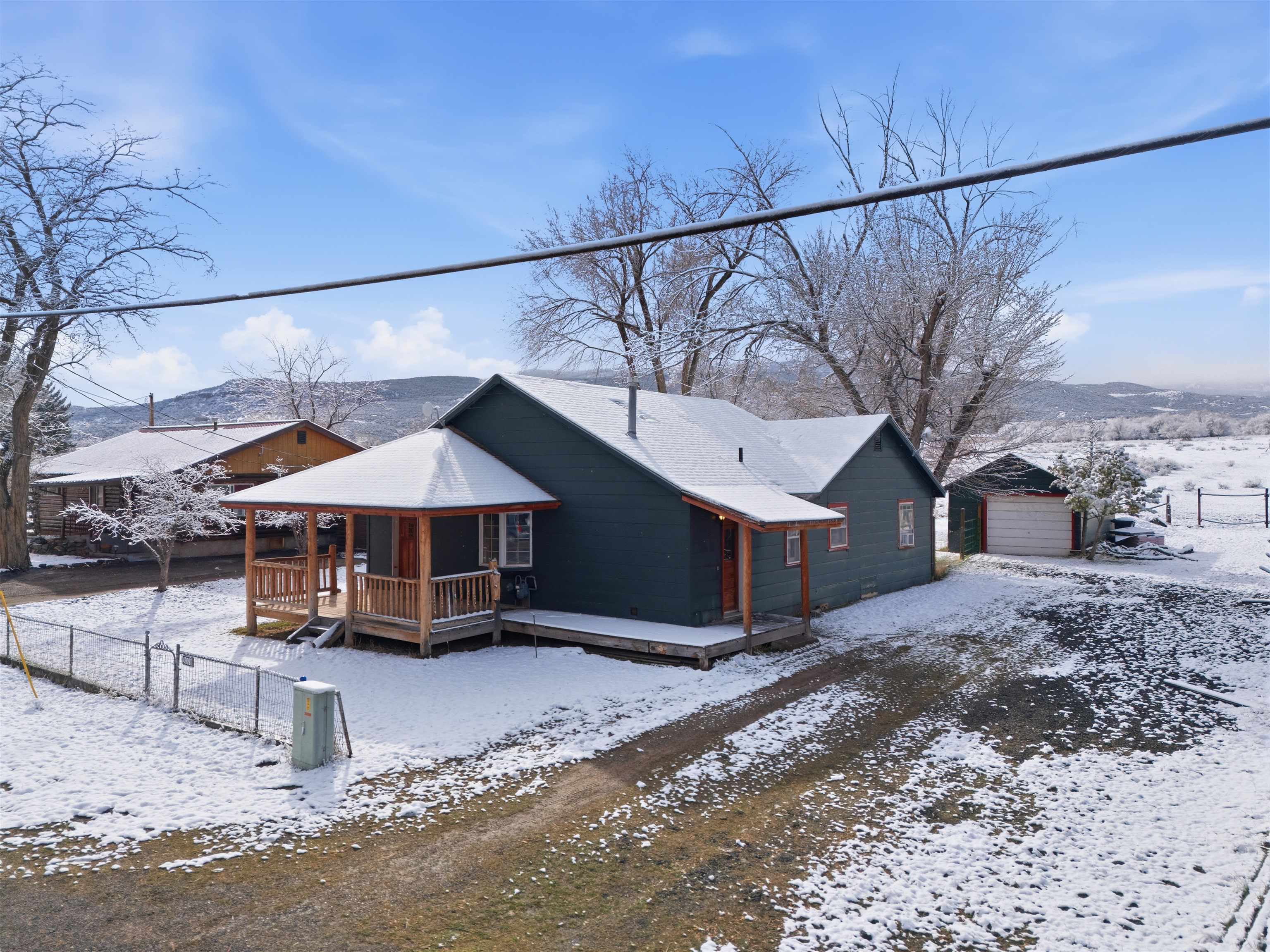 49091 KE Road Mesa, CO 81643 - Photo 2 of 29 a white house covered with tall trees