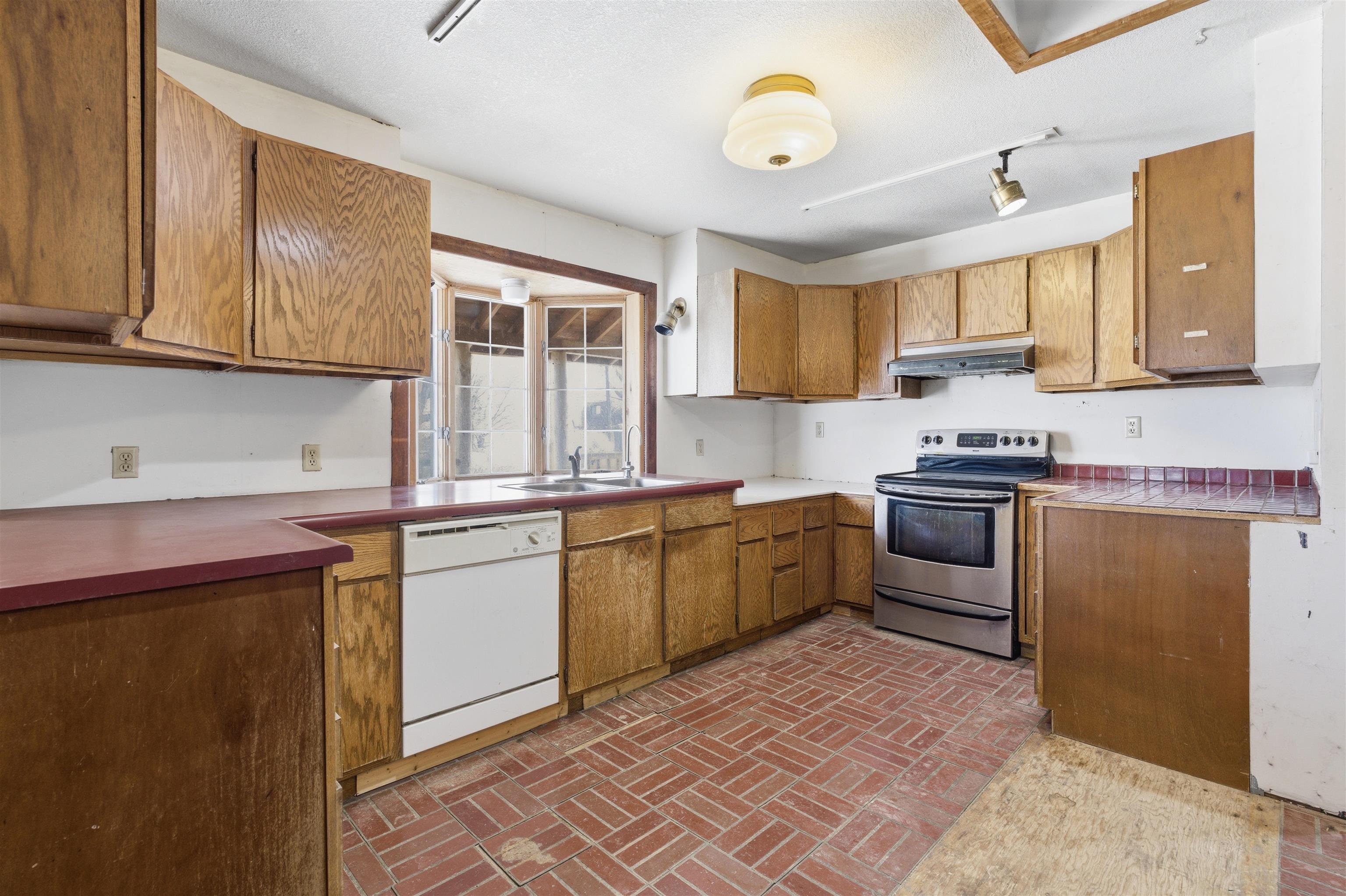 49091 KE Road Mesa, CO 81643 - Photo 24 of 29 a kitchen with granite countertop a sink cabinets stainless steel appliances and a window