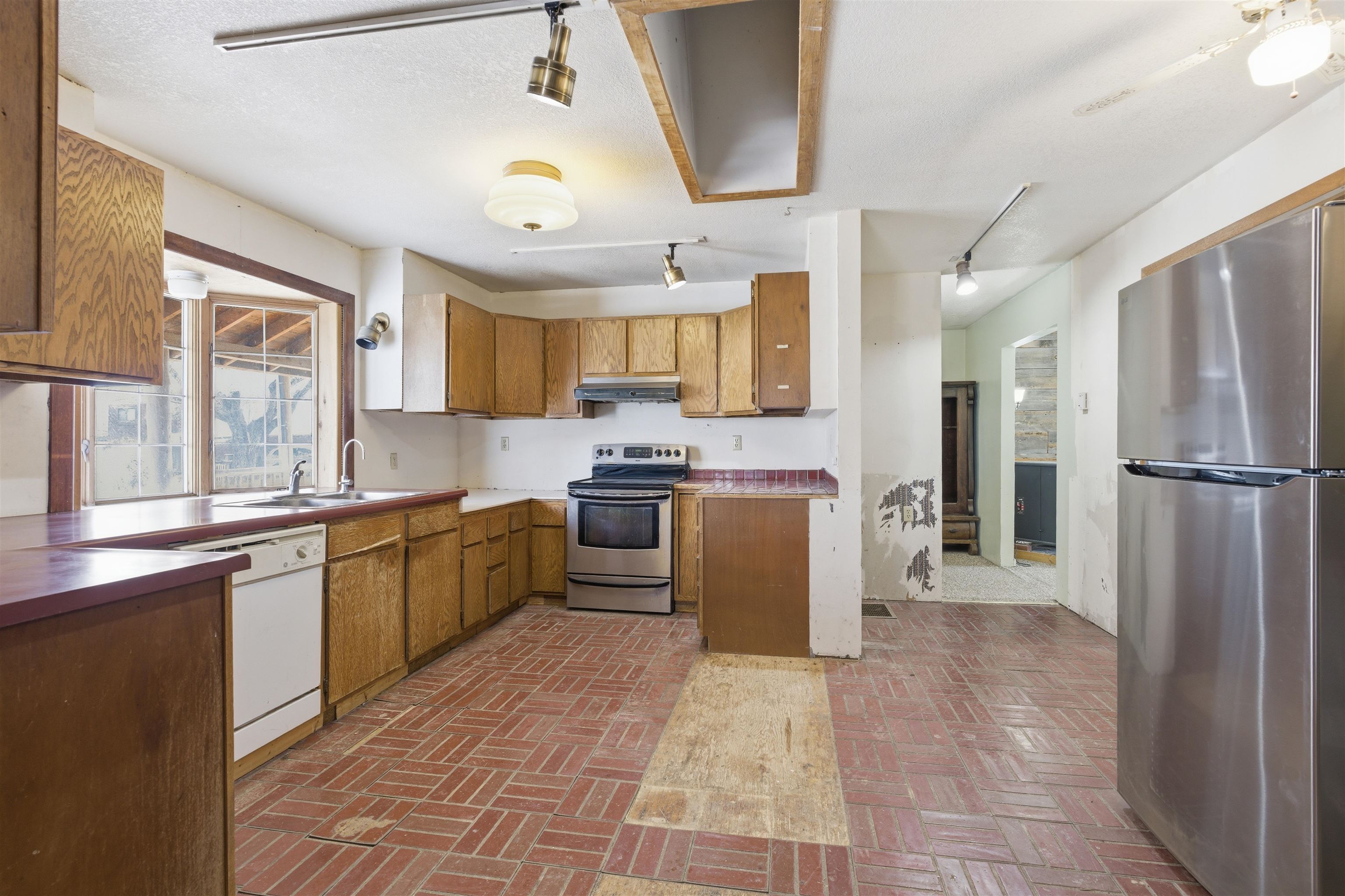 49091 KE Road Mesa, CO 81643 - Photo 27 of 29 a kitchen with granite countertop a refrigerator a sink a stove and cabinets