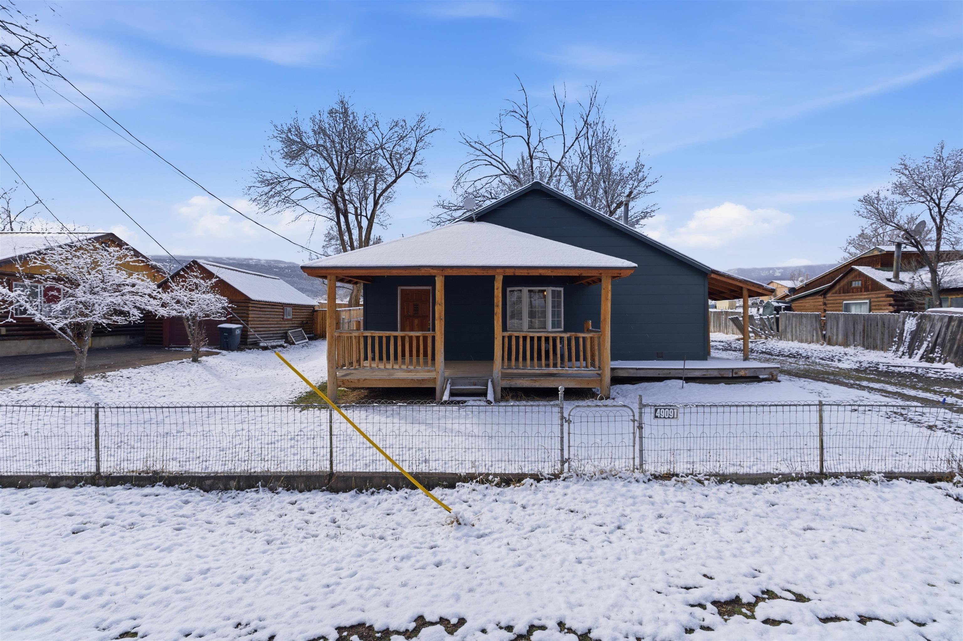 49091 KE Road Mesa, CO 81643 - Photo 4 of 29 a backyard of a house with barbeque oven table and chairs