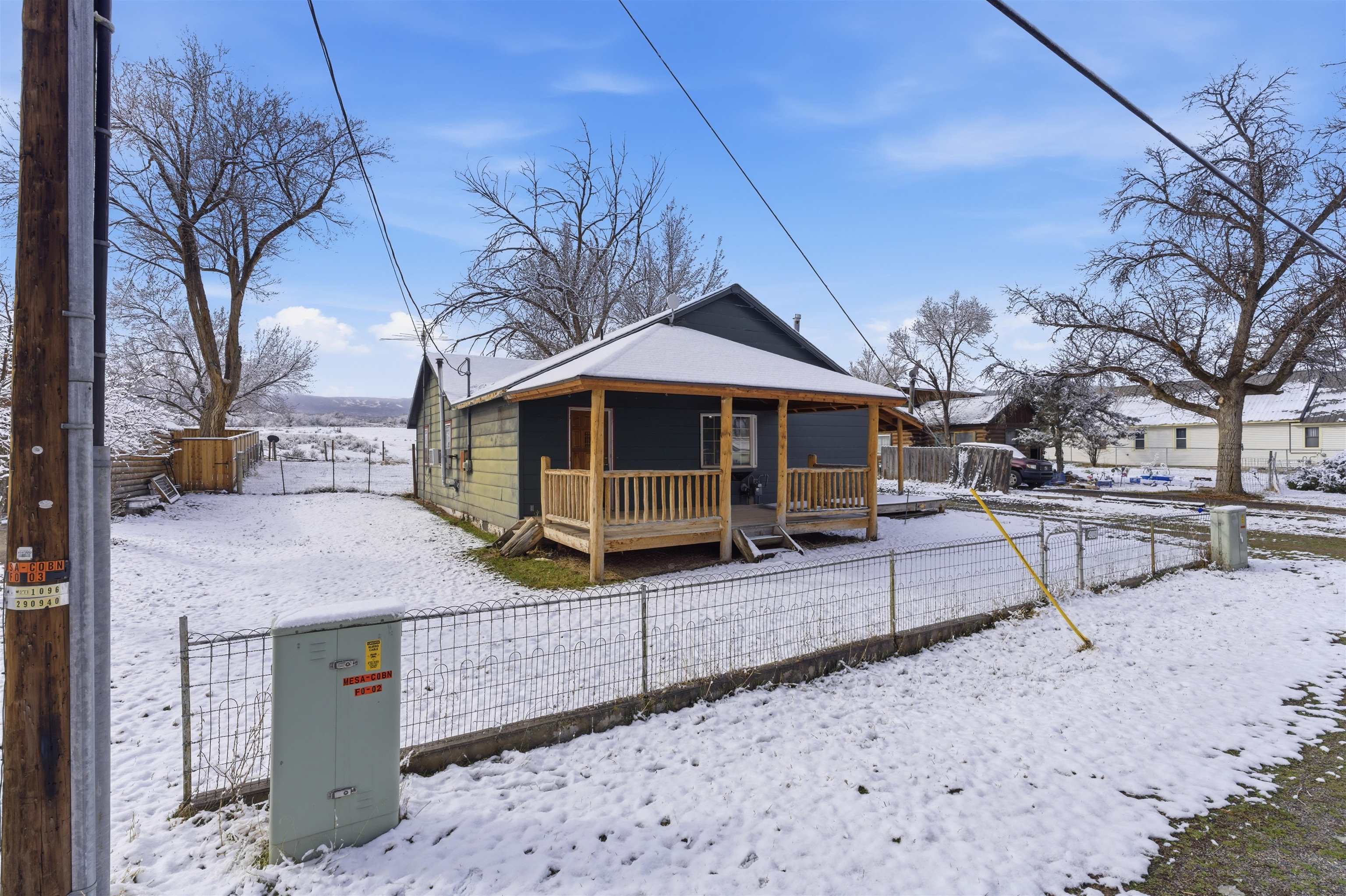 49091 KE Road Mesa, CO 81643 - Photo 5 of 29 a view of house with wooden deck and outdoor seating