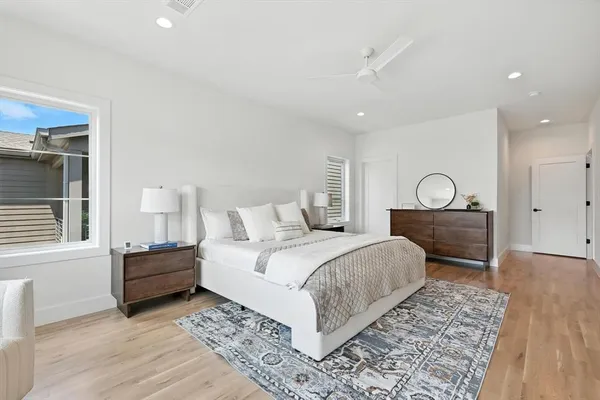 a bedroom with a bed and wooden floor