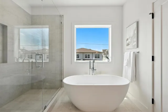 a white bath tub sitting next to a bathroom sink