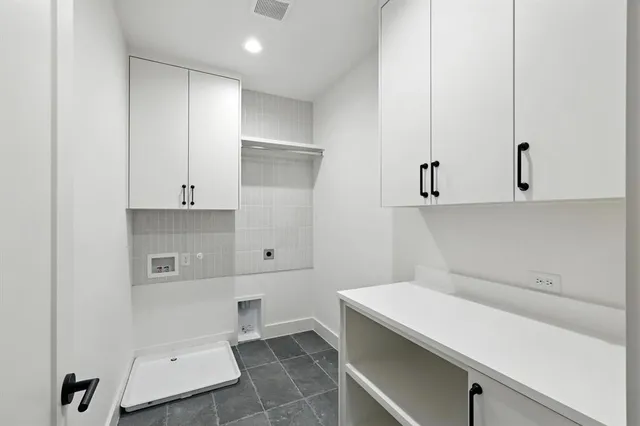 a room with a sink and cabinets