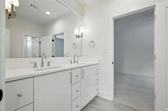 a bathroom with 2 sink and a mirror