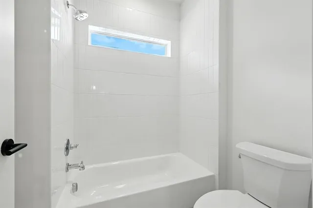 a white bath tub sitting next to a white toilet