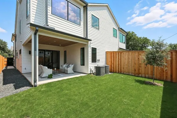 a view of a house with backyard and porch