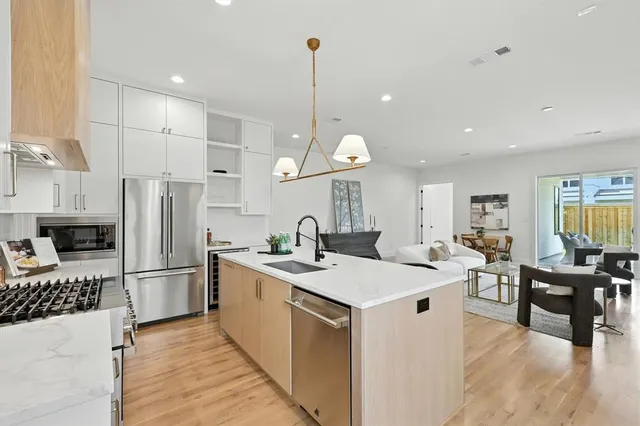 a kitchen with a table chairs stove and microwave