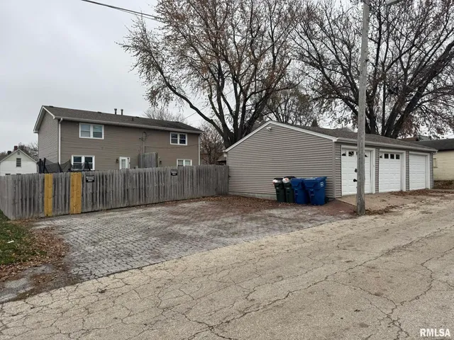 a view of a house with a yard and garage