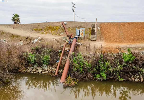 a front view of a building with trees