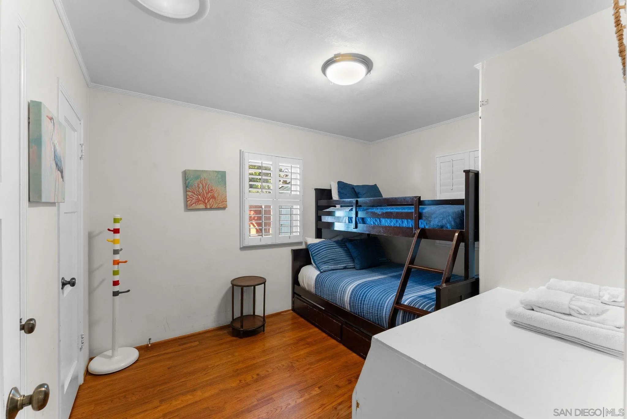 7005 Draper Avenue La Jolla, CA 92037 - Photo 11 of 26 a bedroom with furniture and a wooden floor