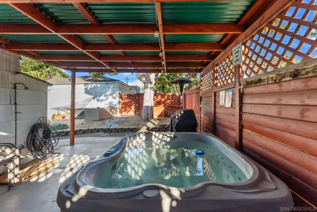 a roof deck with table and chairs