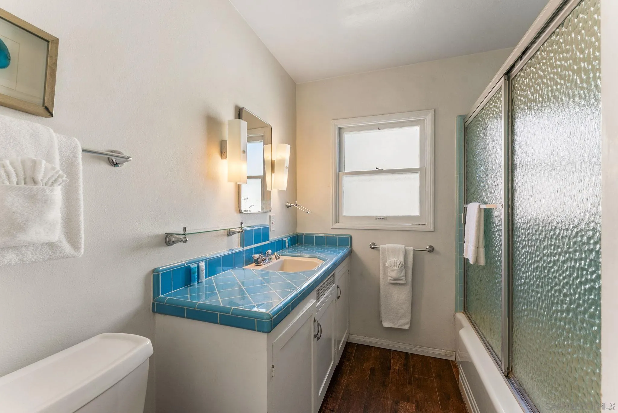 7005 Draper Avenue La Jolla, CA 92037 - Photo 19 of 26 a bathroom with a granite countertop sink a toilet and shower