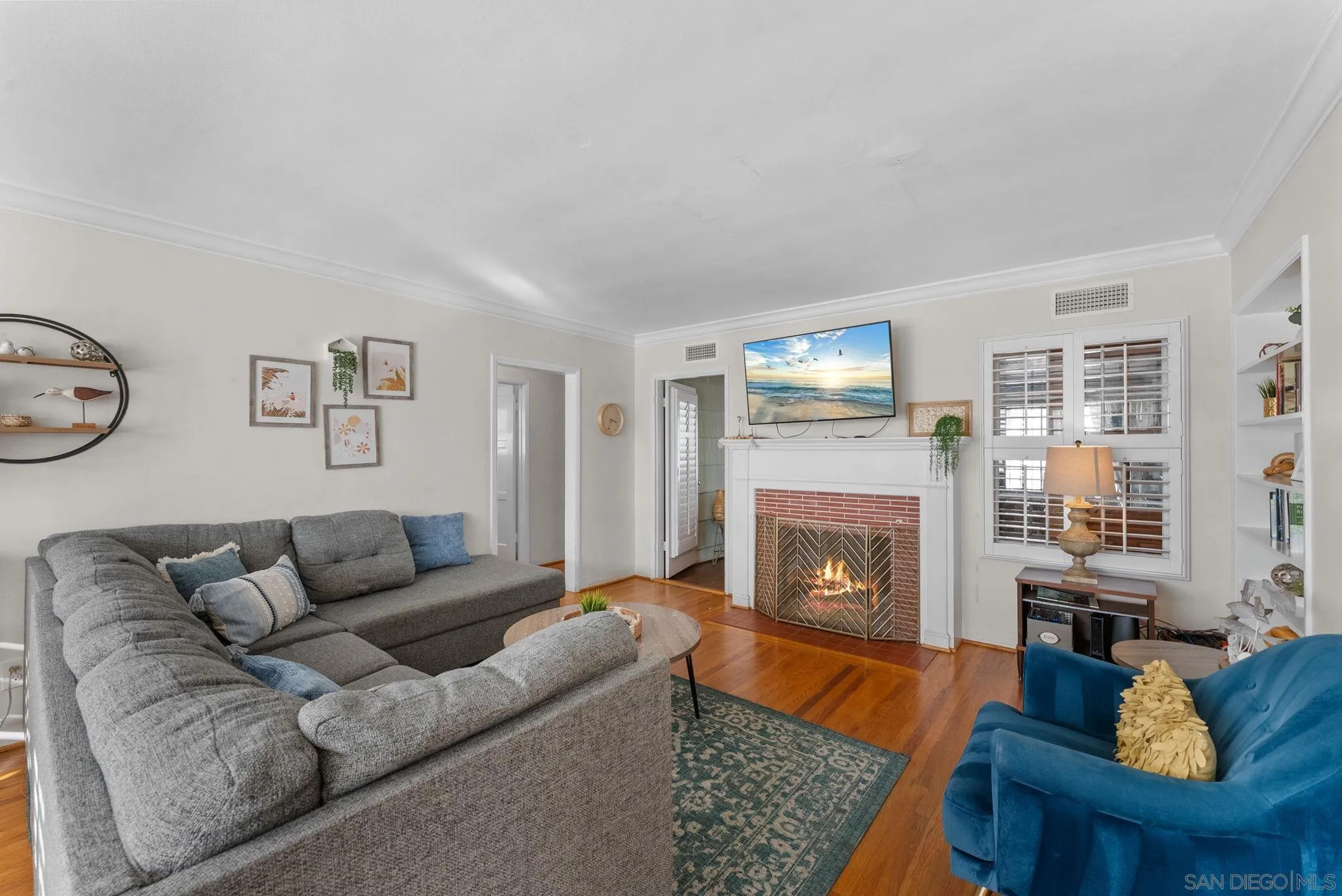 7005 Draper Avenue La Jolla, CA 92037 - Photo 2 of 26 a living room with furniture and a fireplace