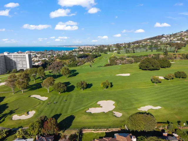 a view of a golf course with an outdoor space