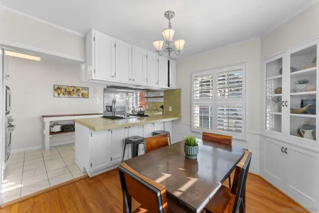 a kitchen with a dining table chairs and stove