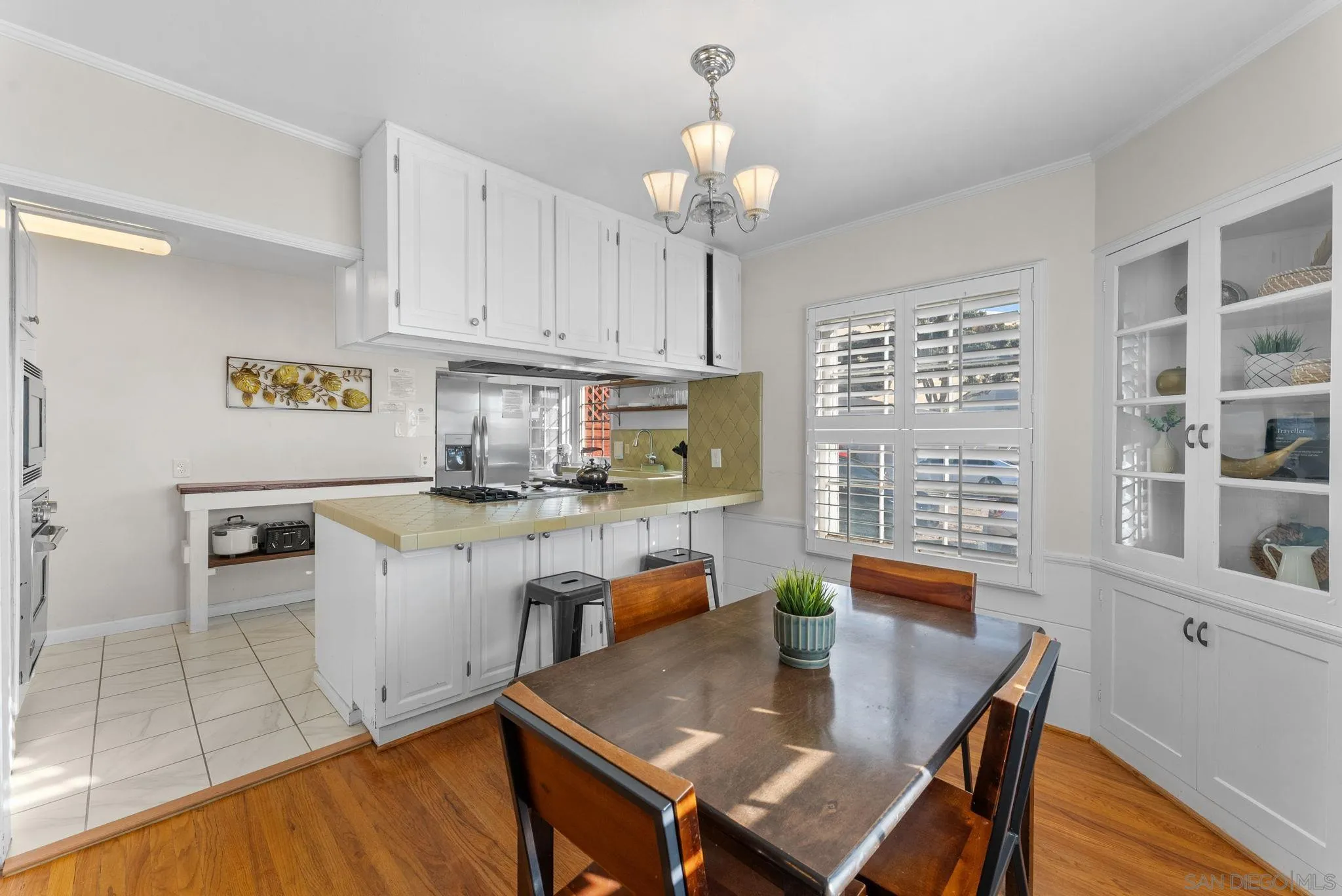 7005 Draper Avenue La Jolla, CA 92037 - Photo 5 of 26 a kitchen with a dining table chairs and stove