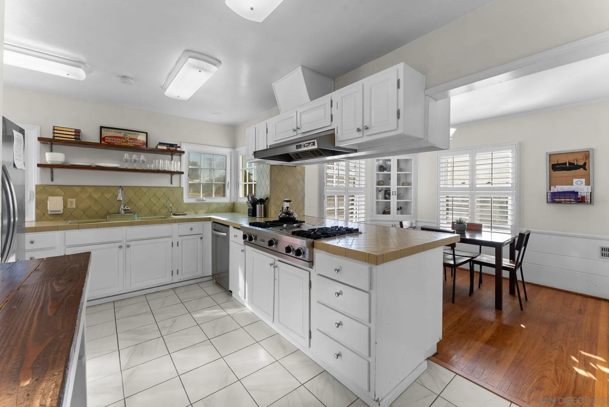 7005 Draper Avenue La Jolla, CA 92037 - Photo 7 of 26 a kitchen with stainless steel appliances granite countertop a stove a sink and a refrigerator