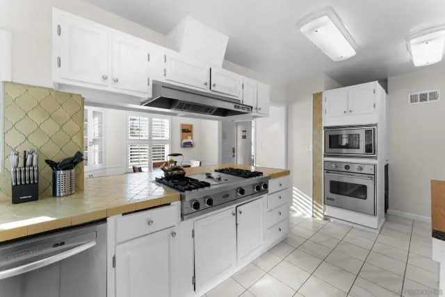 a kitchen with cabinets and appliances