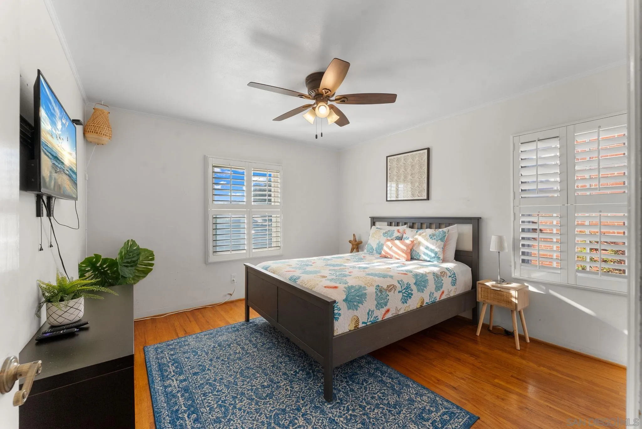 7005 Draper Avenue La Jolla, CA 92037 - Photo 10 of 26 a bedroom with a bed potted plant with the window