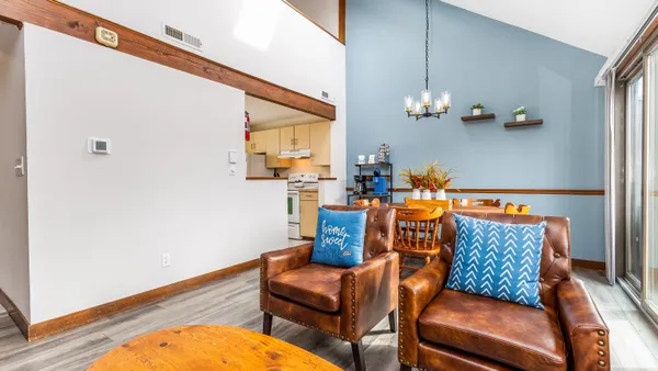 a dining room with furniture and wooden floor