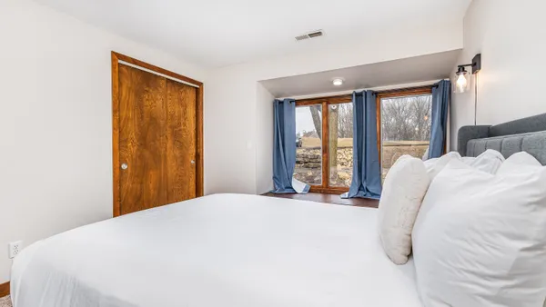 a bedroom with two beds and painted walls