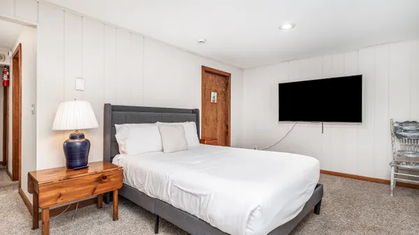 a bedroom with a bed and a window