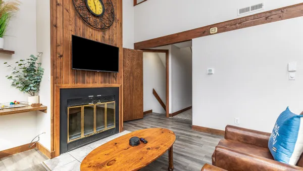 a living room with furniture a flat screen tv and a fireplace