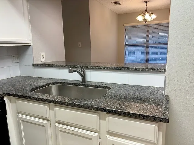 a kitchen with granite countertop a sink and a granite counter tops