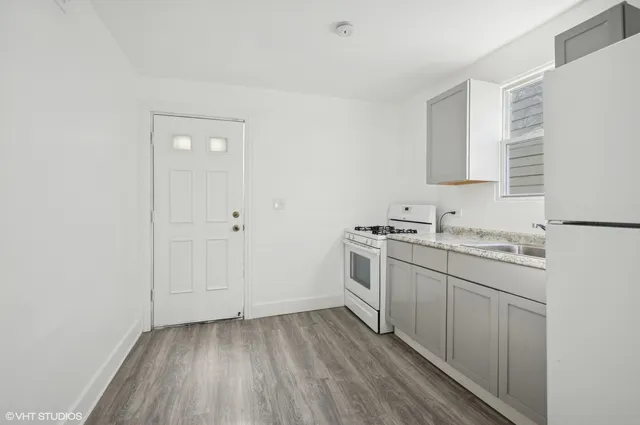 a view of a kitchen with sink cabinets and wooden floor