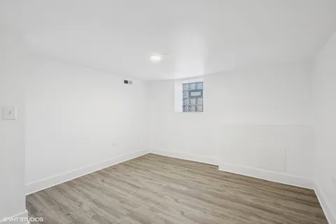 a view of a room with wooden floor and white walls