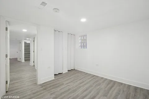 a view of a room with wooden floor