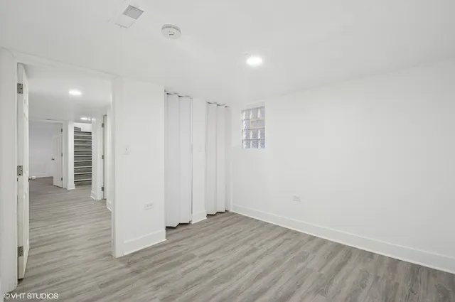 a view of a room with wooden floor
