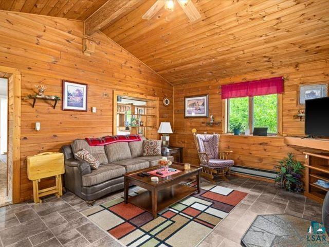 3616 Lavaque Road Hermantown, MN 55811 - Photo 37 of 43 Living area featuring extensive wood-paneled walls and ceiling with an exposed beam
