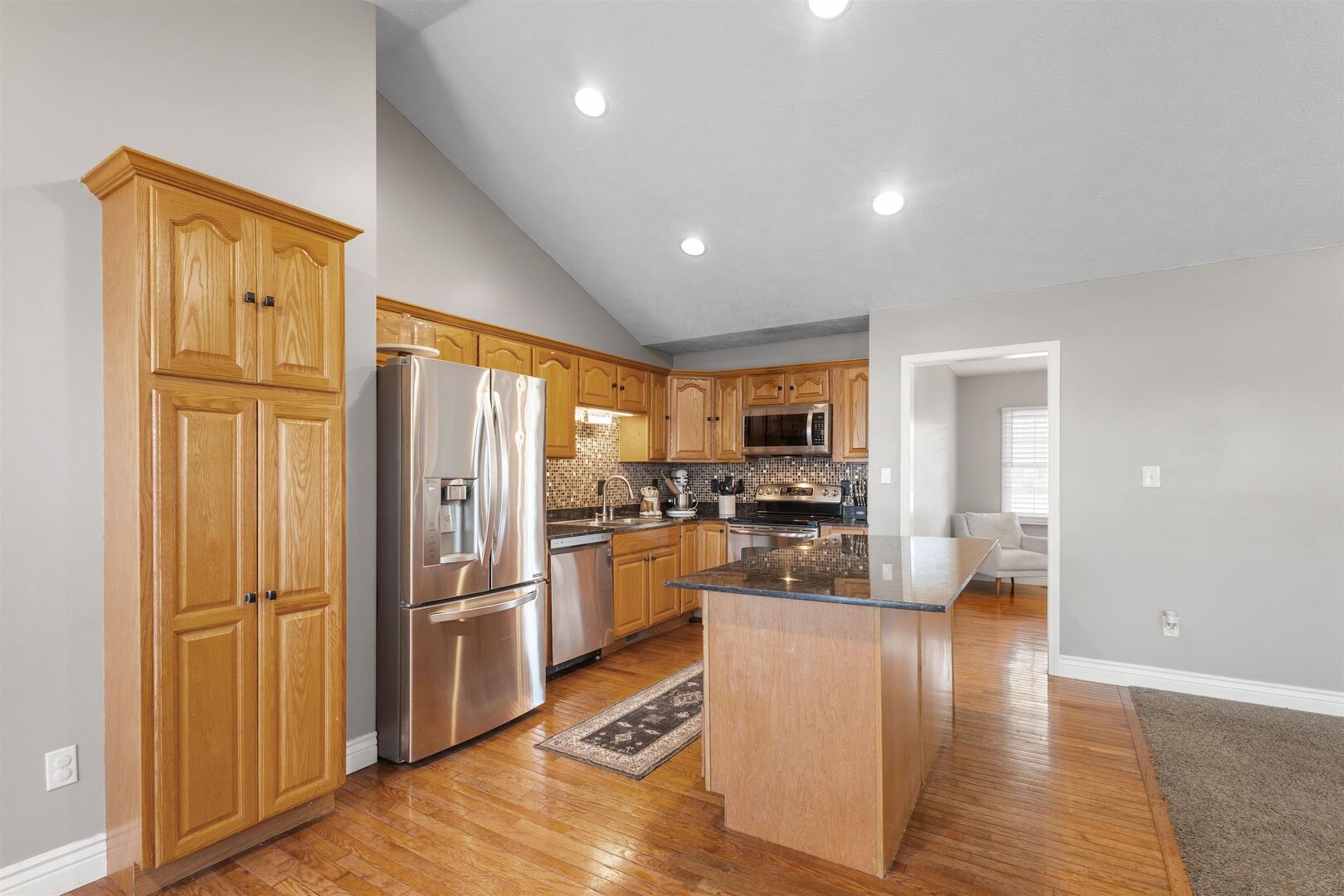 3005 Hickory Ridge Drive, Unit 3005 Herrin, IL 62948 - Photo 5 of 23 a kitchen with stainless steel appliances granite countertop a refrigerator and a stove top oven