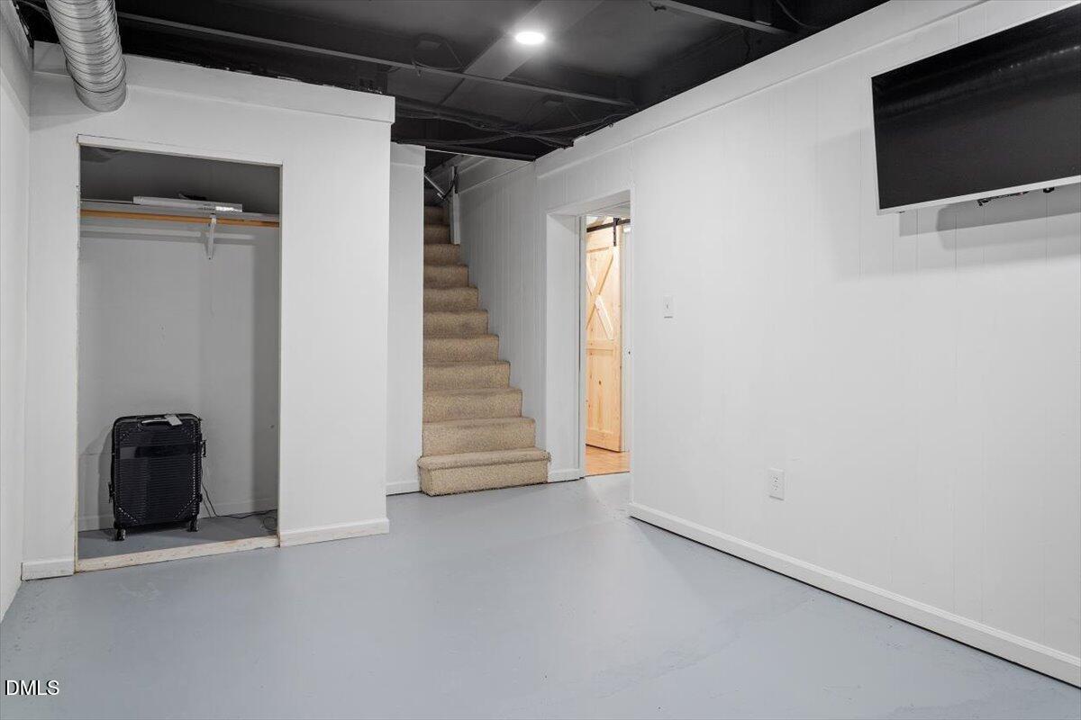 2129 Kelly Road Apex, NC 27502 - Photo 40 of 64 a view of an empty room with a tv