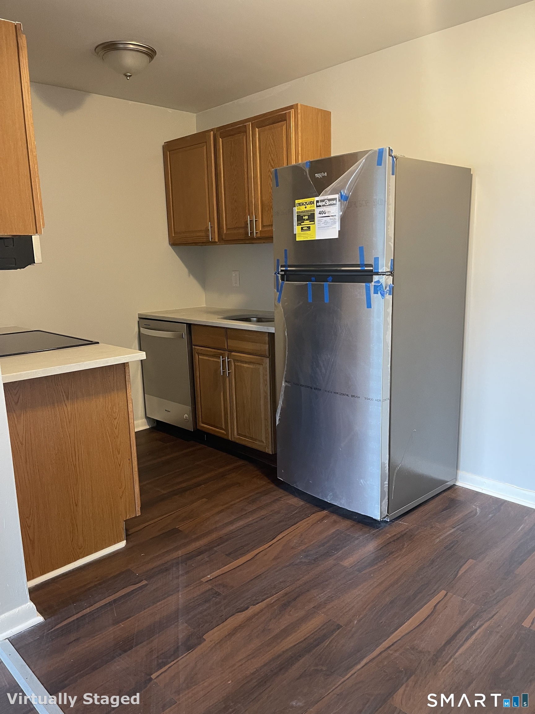 45 Monroe Street, Unit B2 Bridgeport, CT 06605 - Photo 8 of 12 a kitchen with stainless steel appliances a refrigerator and wooden cabinets
