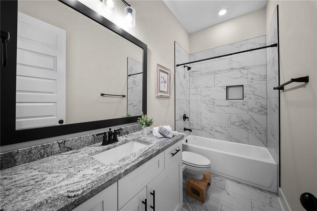 392 London Road Ball Ground, GA 30107 - Photo 21 of 53 a bathroom with a granite countertop sink toilet and shower