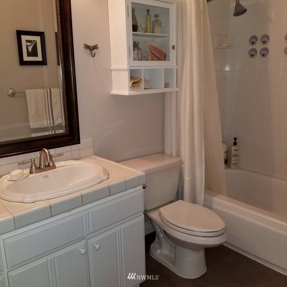 17023 154th Place Southeast Renton, WA 98058 - Photo 13 of 24 a bathroom with a sink a toilet and shower