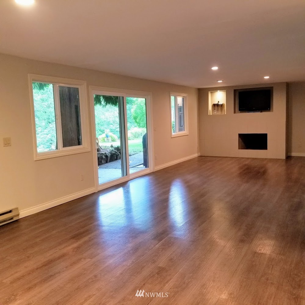 17023 154th Place Southeast Renton, WA 98058 - Photo 17 of 24 a view of an empty room with wooden floor and a window