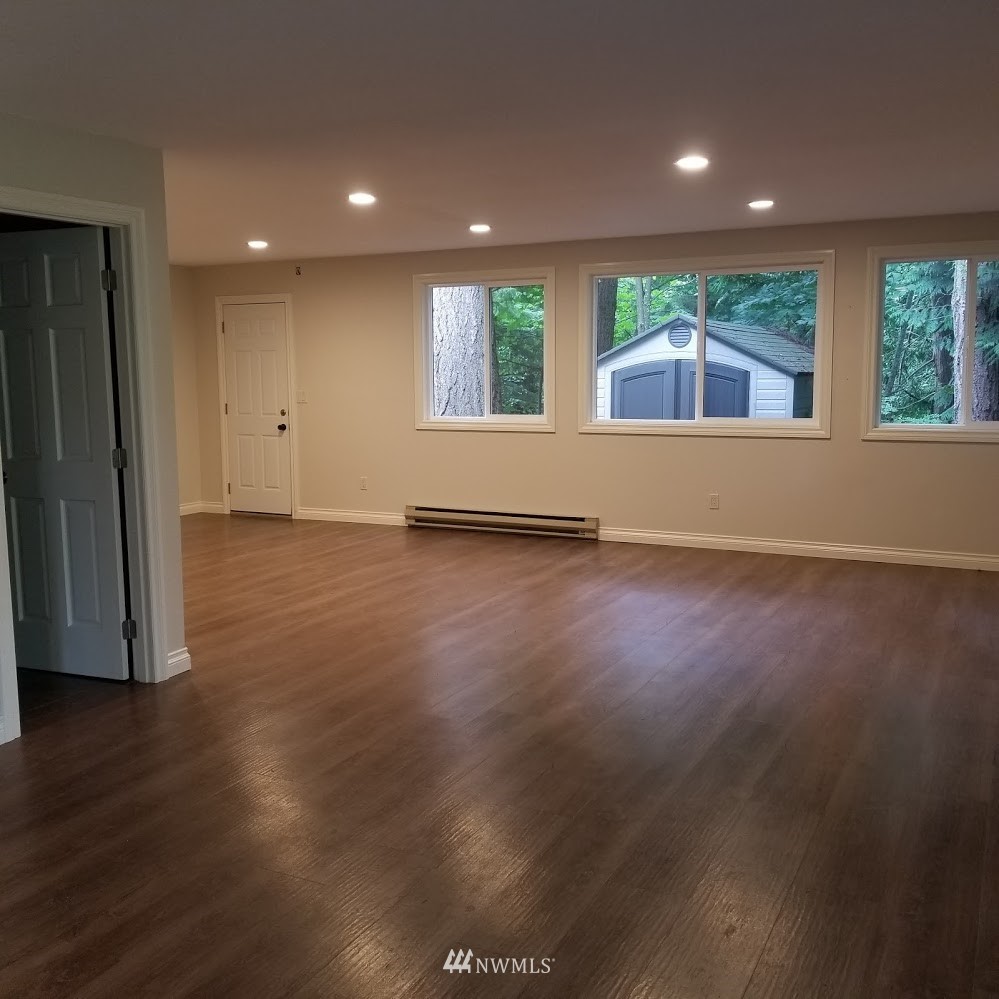 17023 154th Place Southeast Renton, WA 98058 - Photo 18 of 24 an empty room with wooden floor and windows