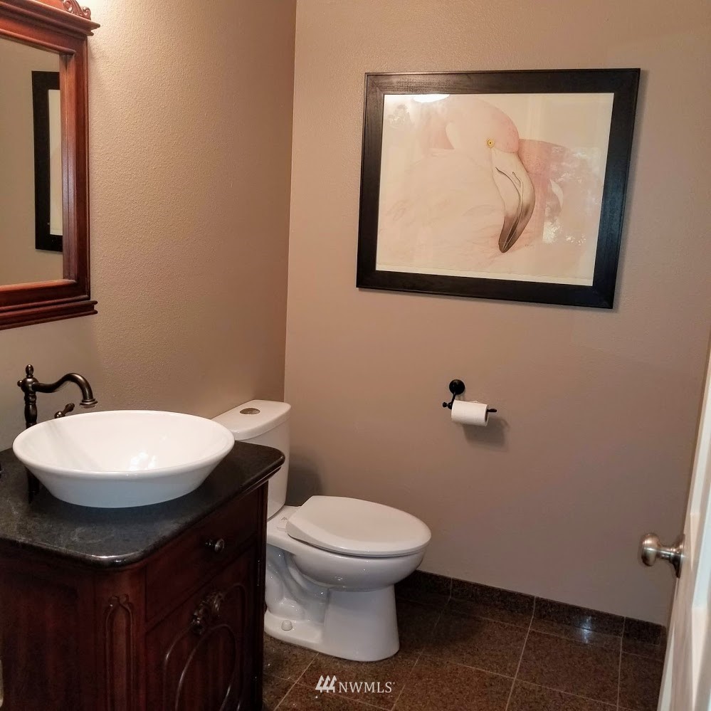 17023 154th Place Southeast Renton, WA 98058 - Photo 19 of 24 a bathroom with a toilet a sink and mirror