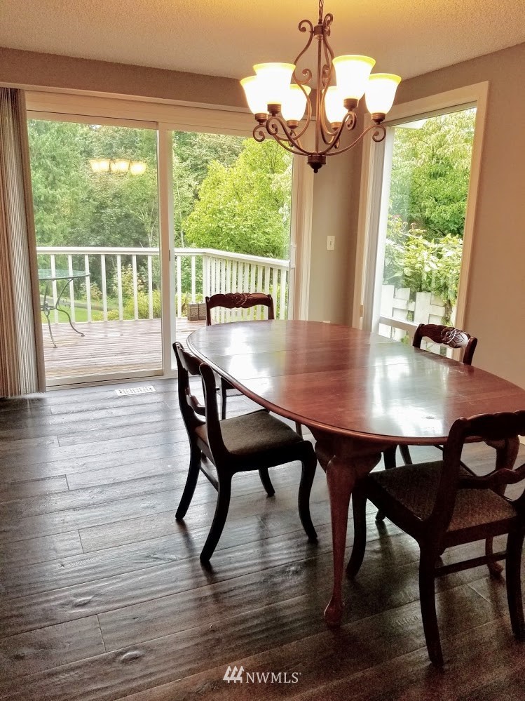 17023 154th Place Southeast Renton, WA 98058 - Photo 4 of 24 a view of a dining room with furniture window and wooden floor