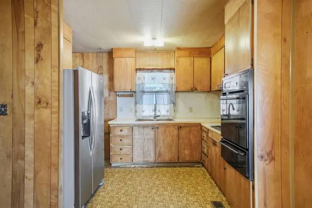 a kitchen with cabinets and appliances