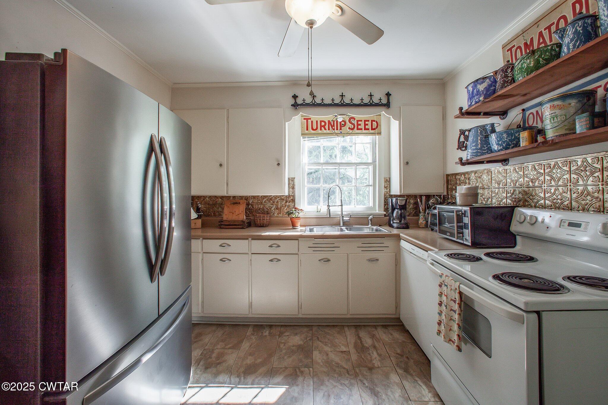 302 Walnut Street Jackson, TN 38301 - Photo 12 of 38 a kitchen with stainless steel appliances granite countertop a refrigerator a sink and a stove