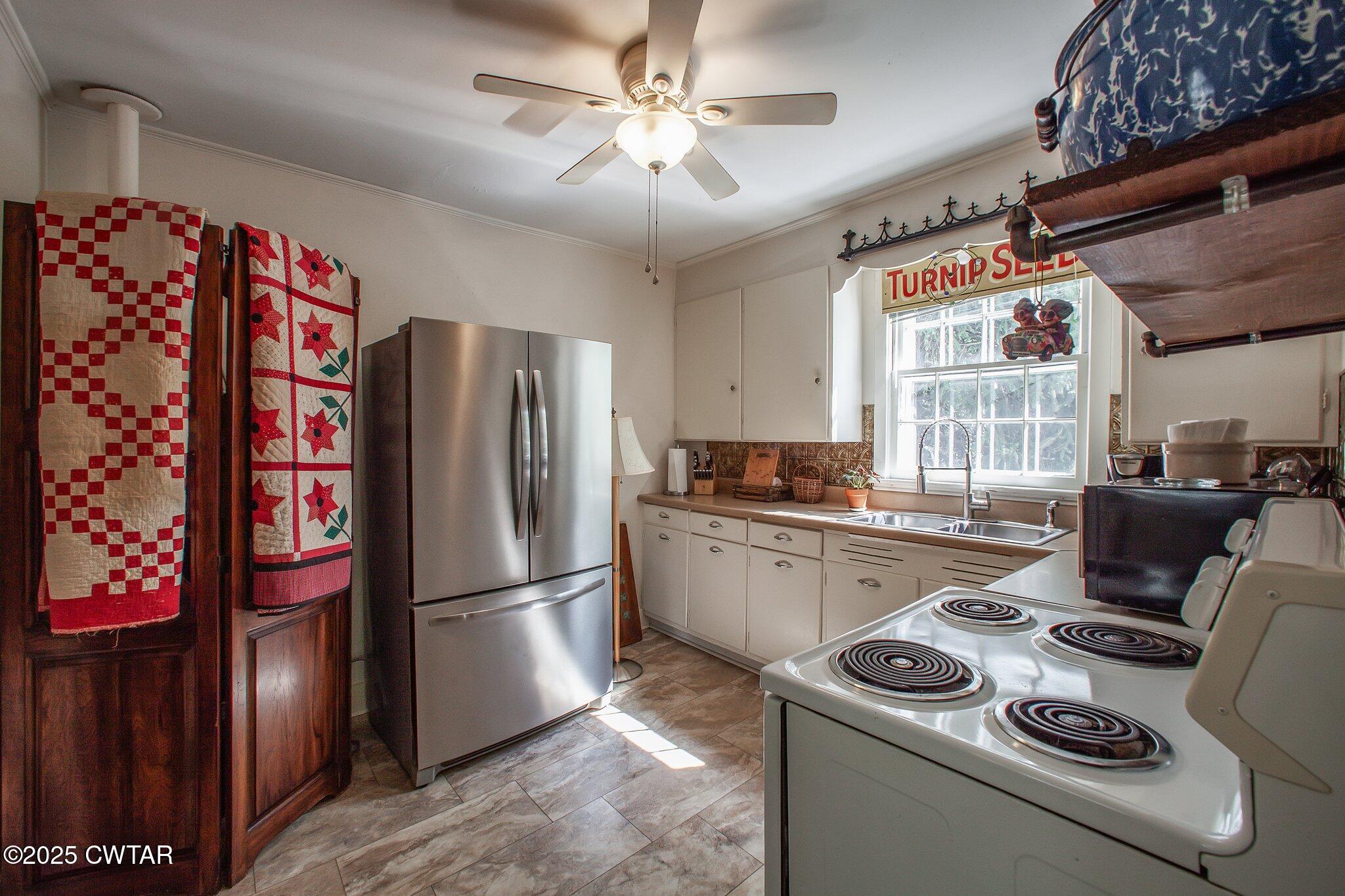 302 Walnut Street Jackson, TN 38301 - Photo 14 of 38 a kitchen with stainless steel appliances granite countertop a refrigerator a stove and a sink with wooden floors